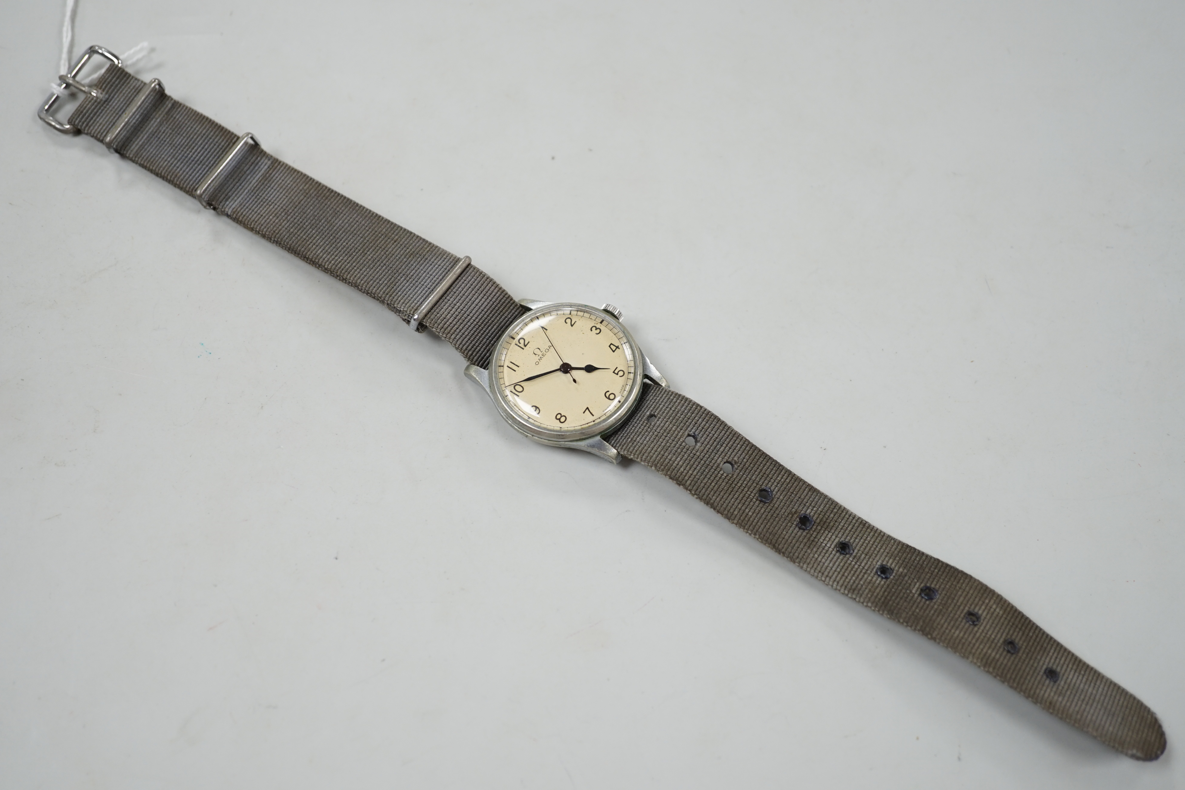 A gentleman's early 1940's stainless steel military issue Omega manual wind wrist watch, on fabric strap, the case back inscribed 'HS arrow 8 over 3282', movement c.30T2.